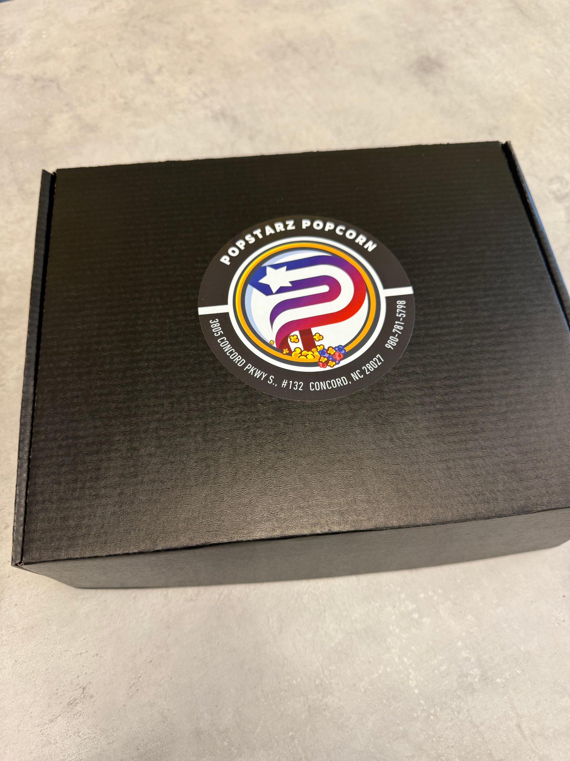 Popstarz Popcorn gift box in black and gold packaging